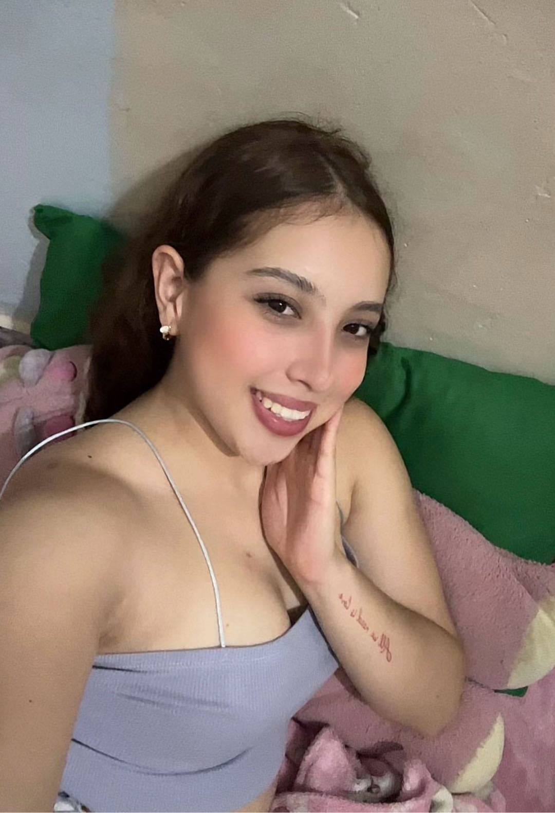 Woman in a lavender top taking a relaxed selfie